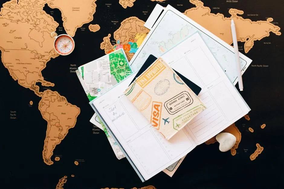 Travel documents, visa stamps, and a compass laid out on a world map, illustrating the paperwork behind an international program application.